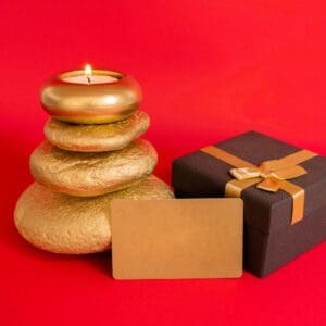 A candle and some rocks are next to a gift.