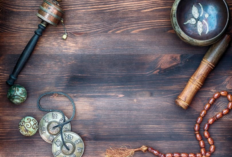 A wooden table with various items on it.